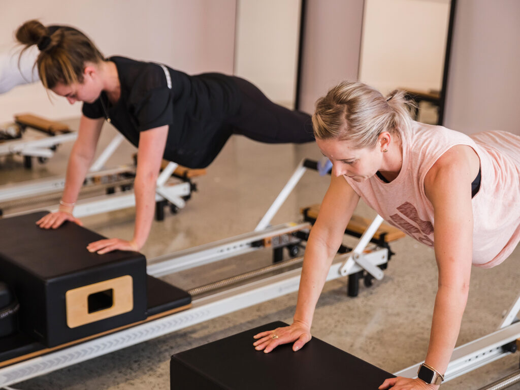 Women doing reformer pilates routine